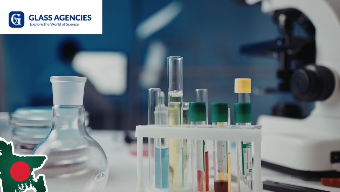 Laboratory glassware with test tubes and flasks on a workbench, Glass Agencies branding visible, setup for laboratory equipment suppliers in Bangladesh